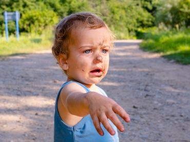 surprised-little-boy-is-squatting-on-the-grass-bo-2024-12-04-22-21-06-utc